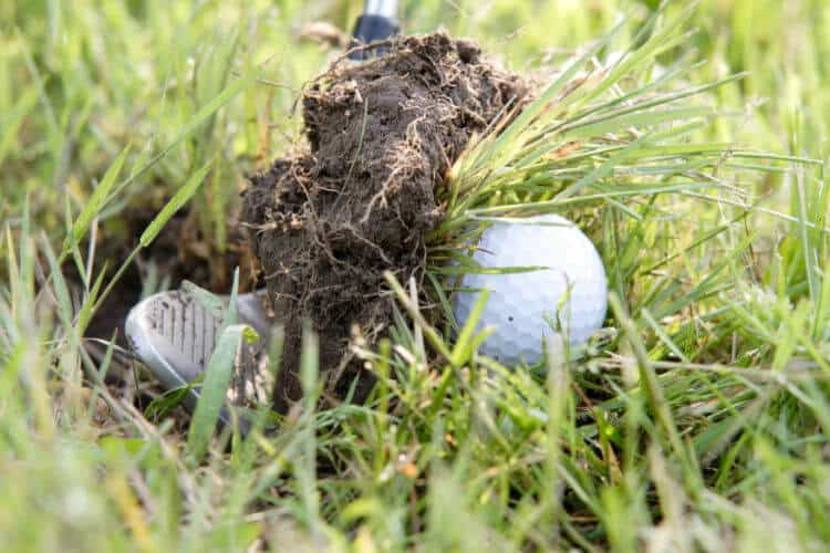 A huge golf club iron divot
