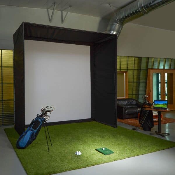 An indoor golf simulator setup with impact screen, frame, and enclosure.