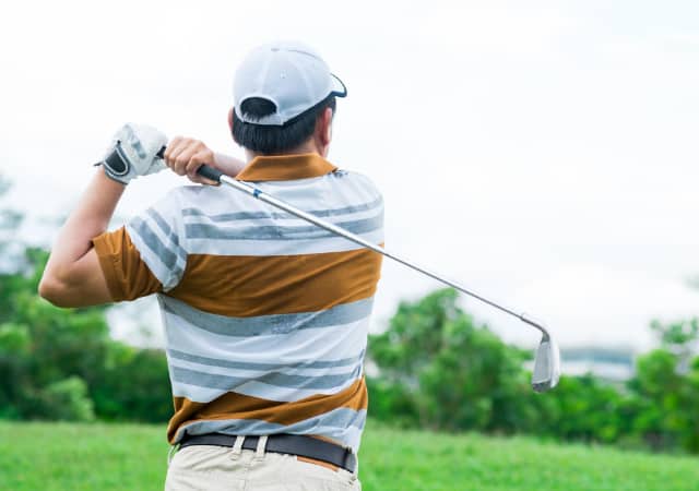 A golfer looking at his golf ball after a successful swing on the golf course