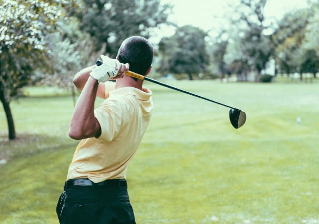 Golfer swinging hard.