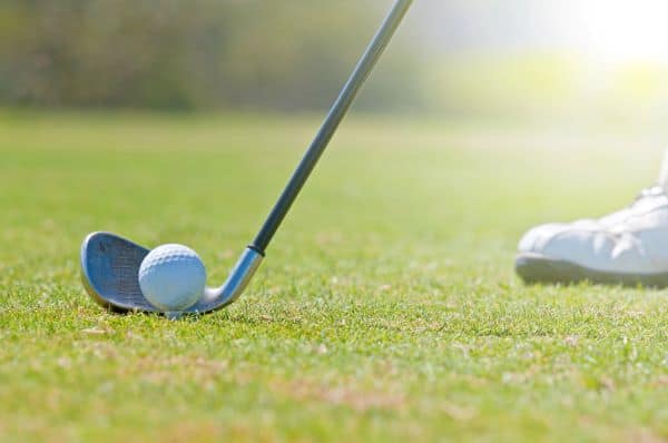 Golf club and golf ball on the golf course