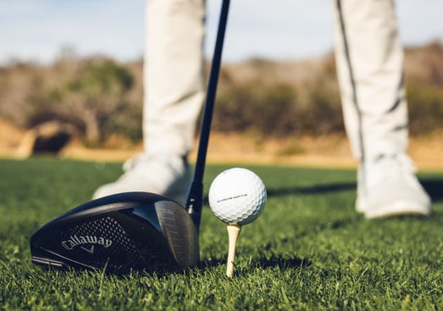 Golfer preparing to swing a Callaway Rogue ST Driver on the golf course