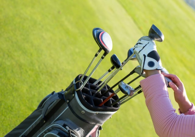 Professional Golf Player Choosing the Golf Clubs in Bag at Golf Course